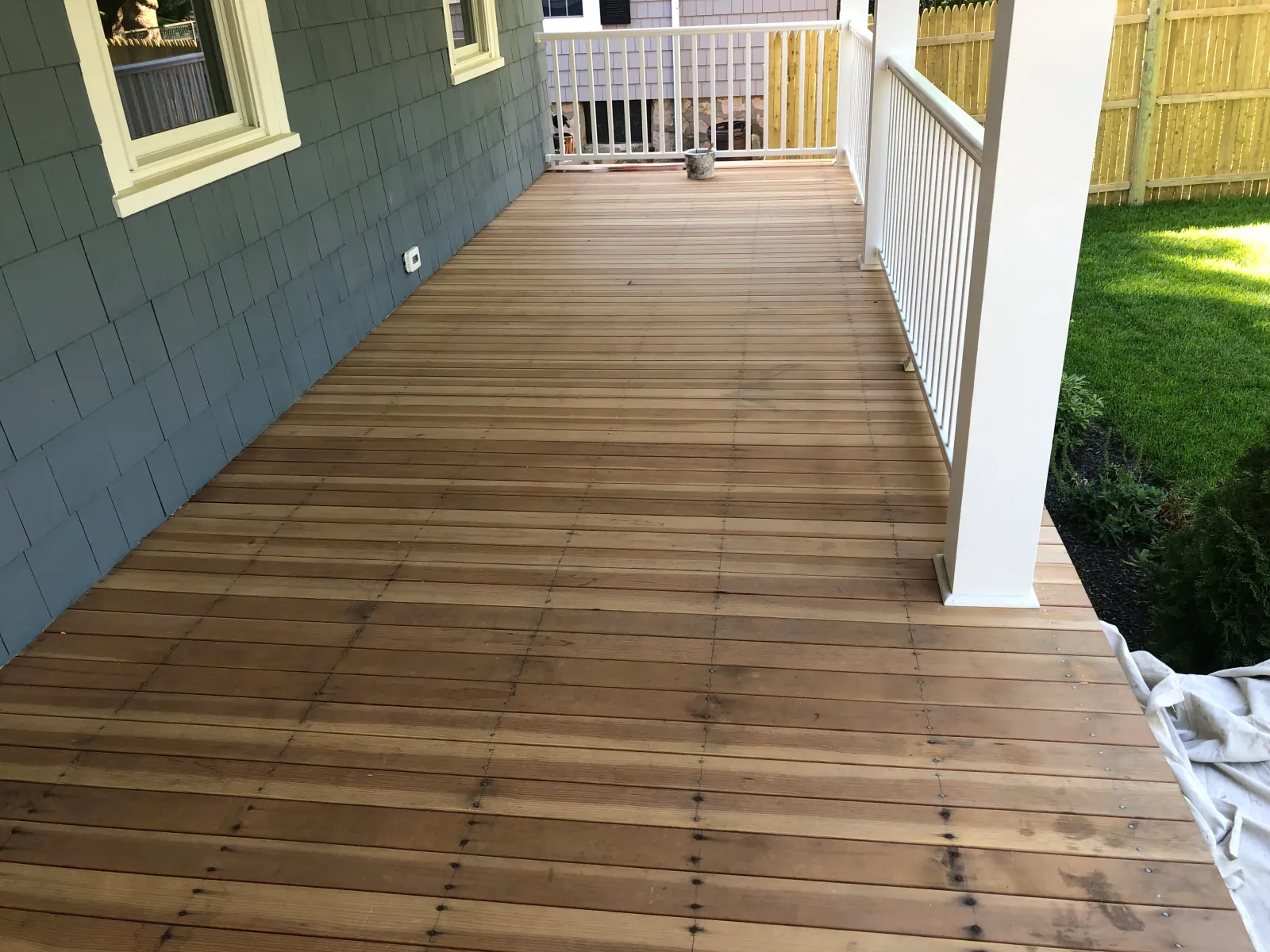 Same deck before — weathered gray boards