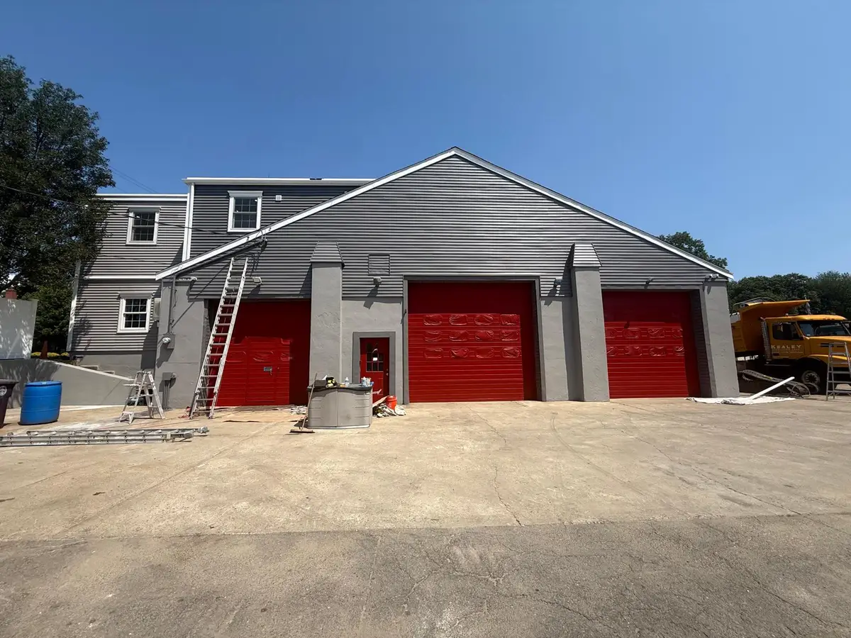 Weymouth, MA garage after painting: red overhead doors and gray pilasters
