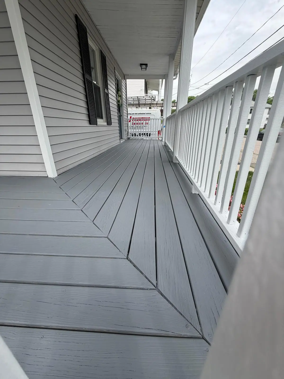 Side porch walkway painted gray with white balusters in Norwood, MA