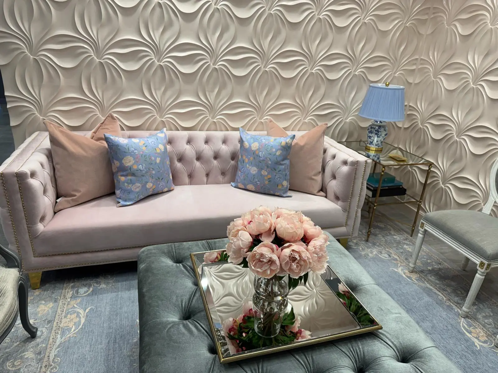 3D floral textured wall in pale blush behind a pink velvet sofa