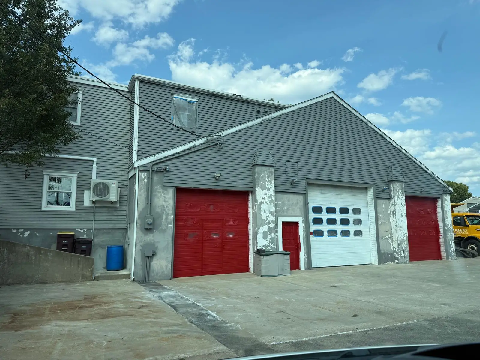 Weymouth garage seen from the street after painting with red doors
