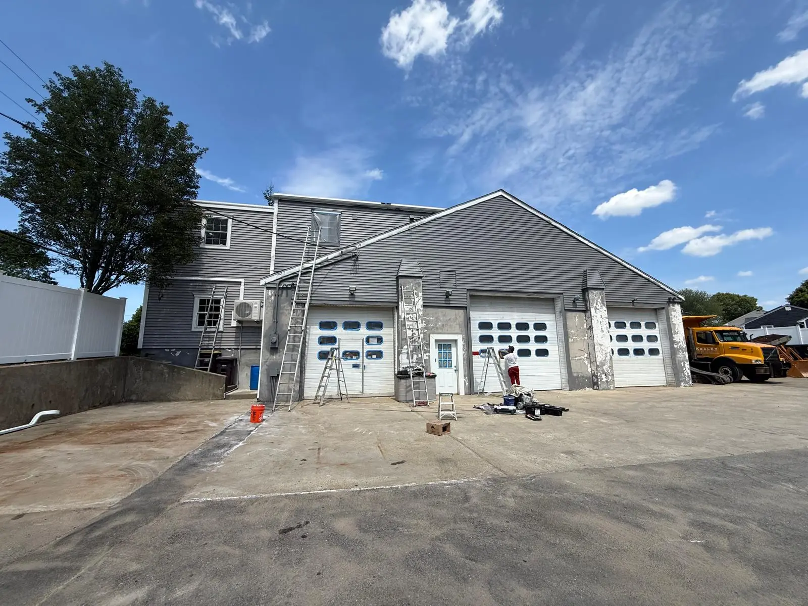 Weymouth garage before painting: white doors and peeling white paint on the masonry pilasters
