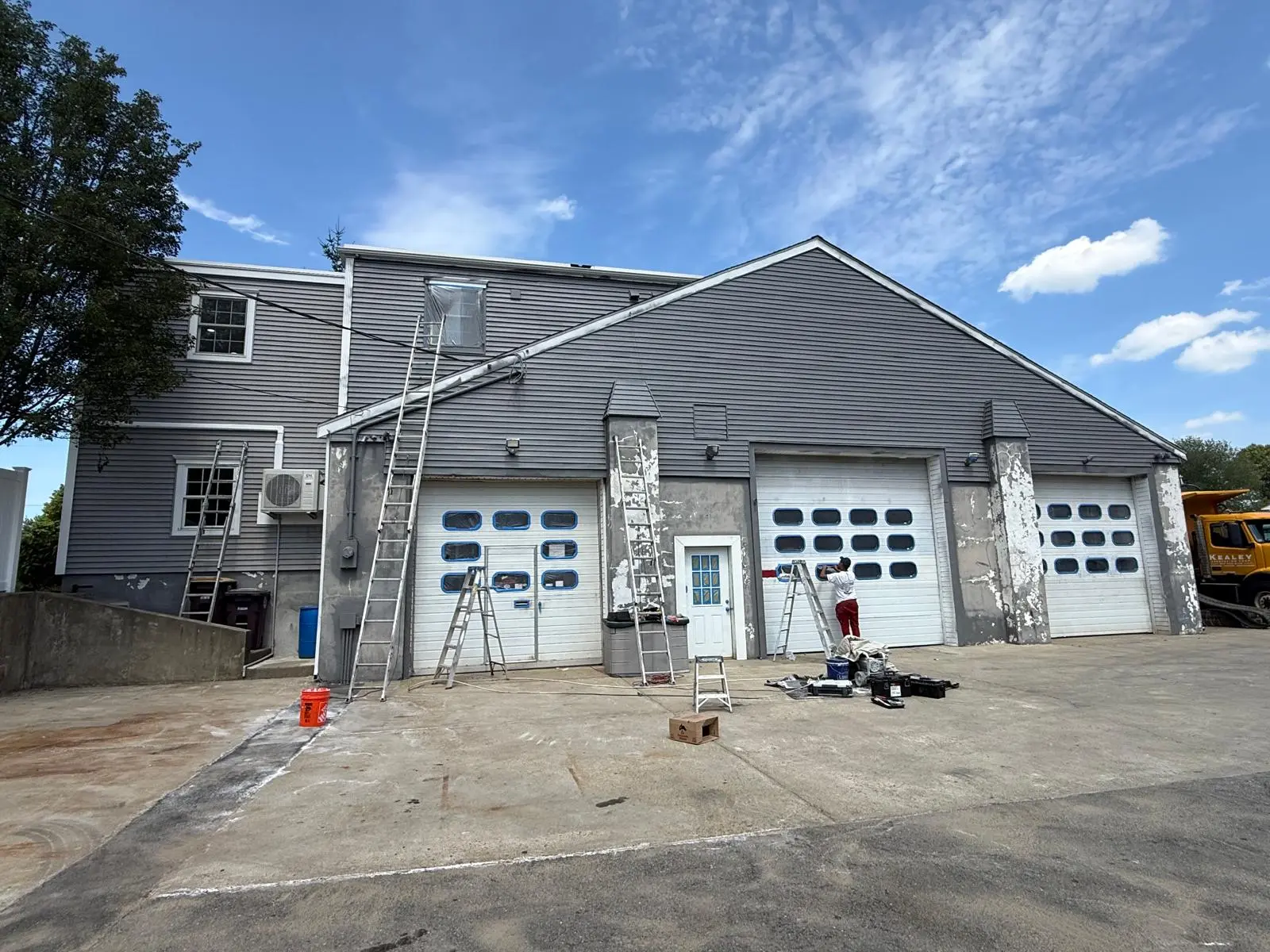 Wide view of the Weymouth garage with ladders set up during prep
